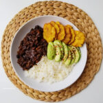 Haitian White Rice black beans sauce and fried plantains bowl